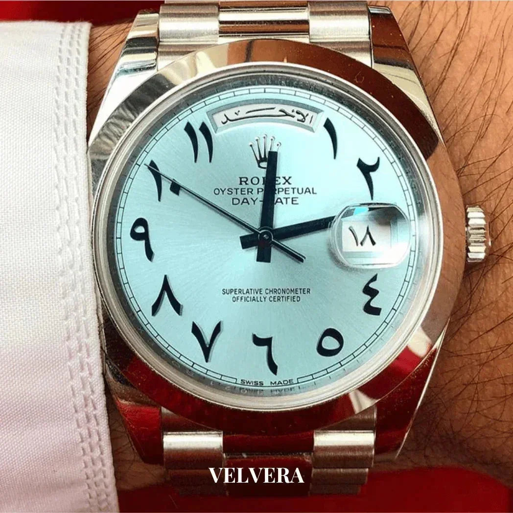 Rolex Oyster Perpetual Day-Date watch with Arabic numerals and silver bracelet on wrist