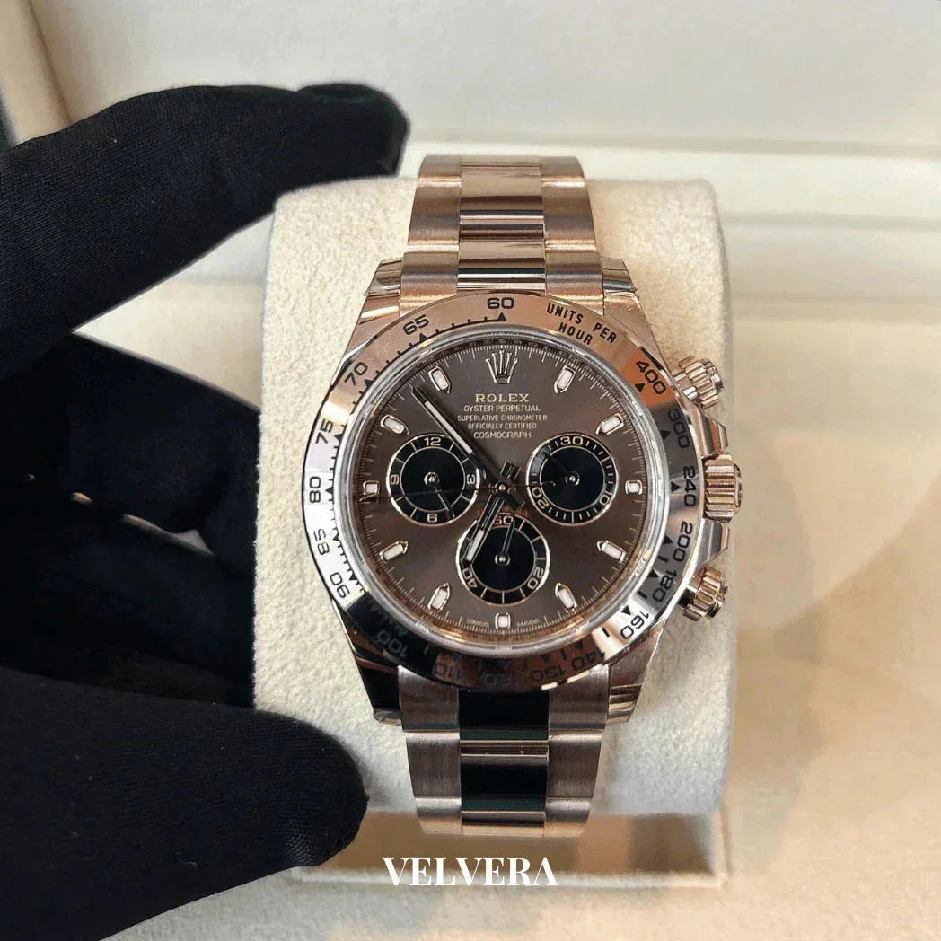 Rolex Daytona rose gold chronograph watch on cushion, luxury timepiece display, Velvera