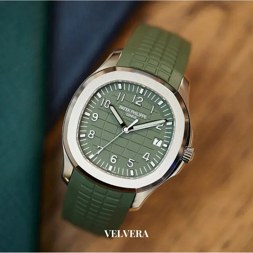 Green Patek Philippe watch with rubber strap on wooden surface, VELVERA branding visible
