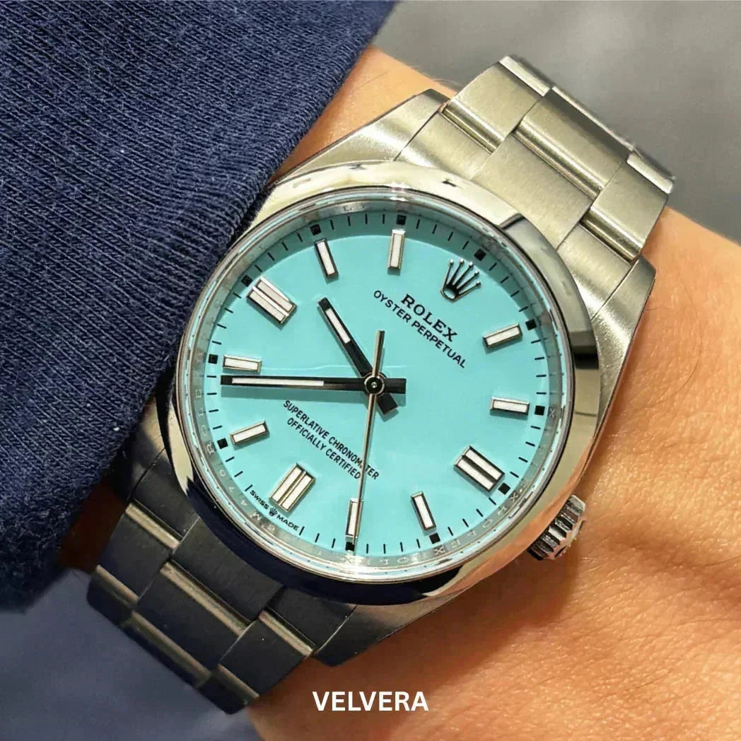 Rolex Oyster Perpetual watch with turquoise dial and stainless steel bracelet on wrist
