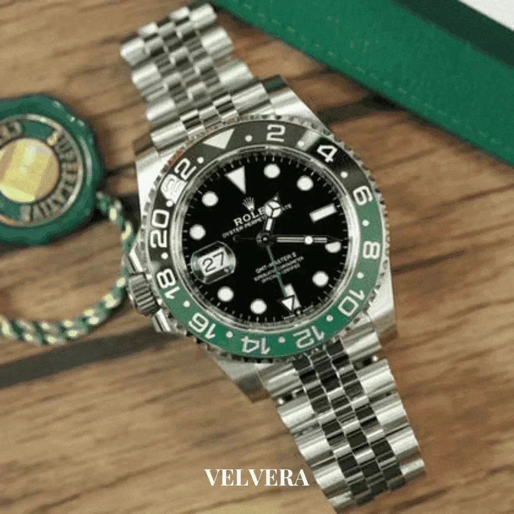 Luxury Rolex GMT-Master II stainless steel watch with green bezel on wood surface, Velvera