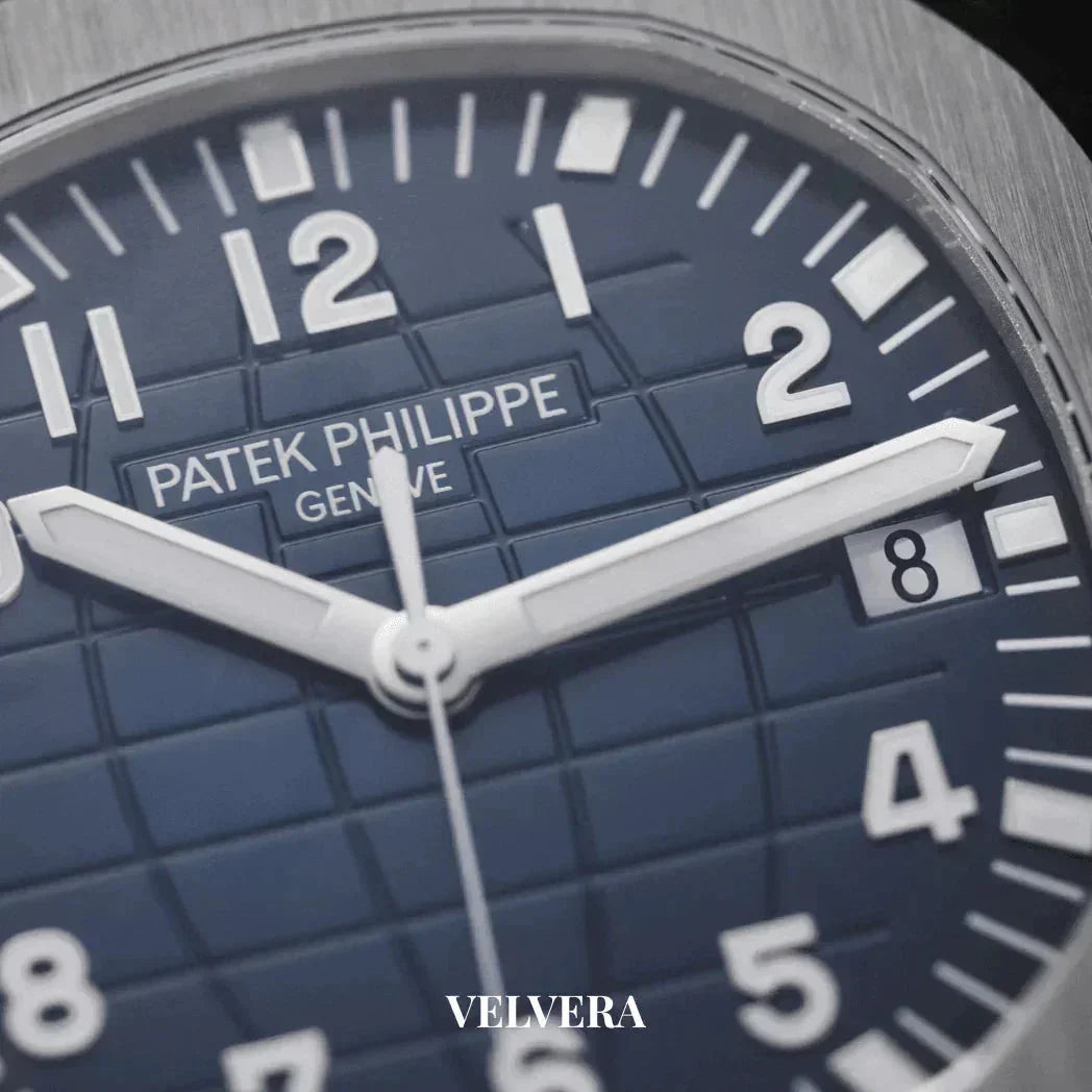 Close-up of Patek Philippe blue dial luxury watch with white hour markers and date display