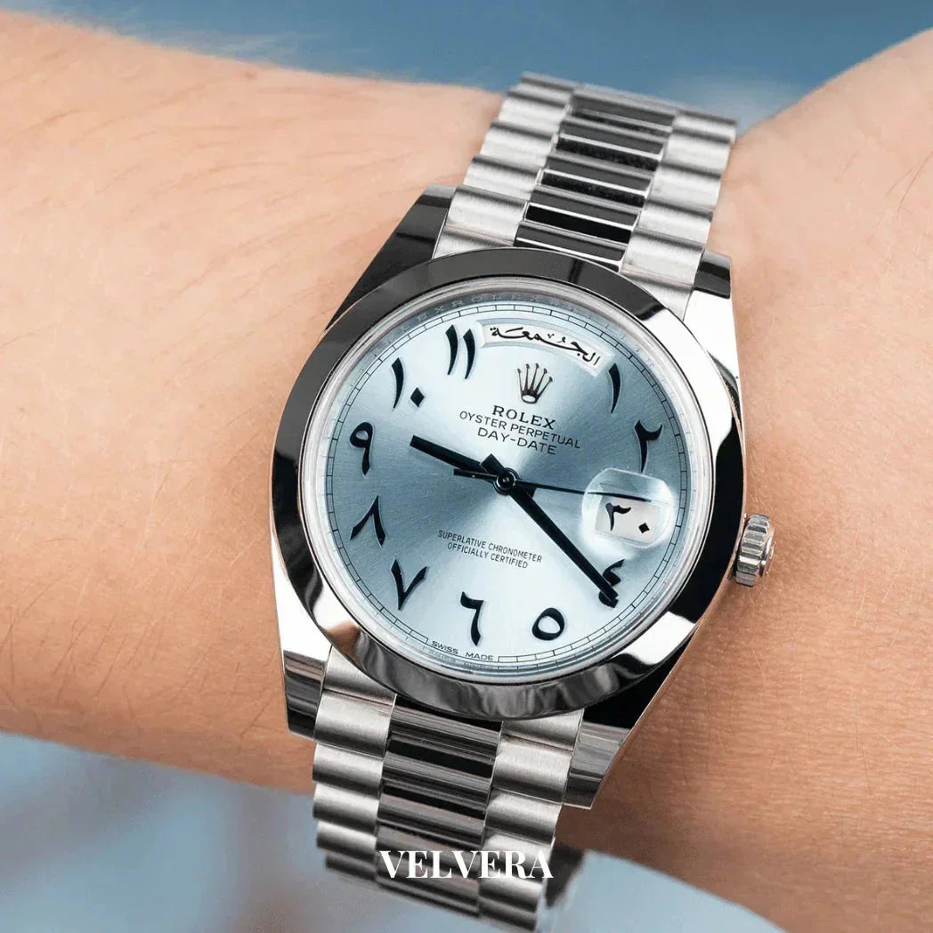 Rolex Oyster Perpetual Day-Date watch with Arabic numerals and silver bracelet on wrist