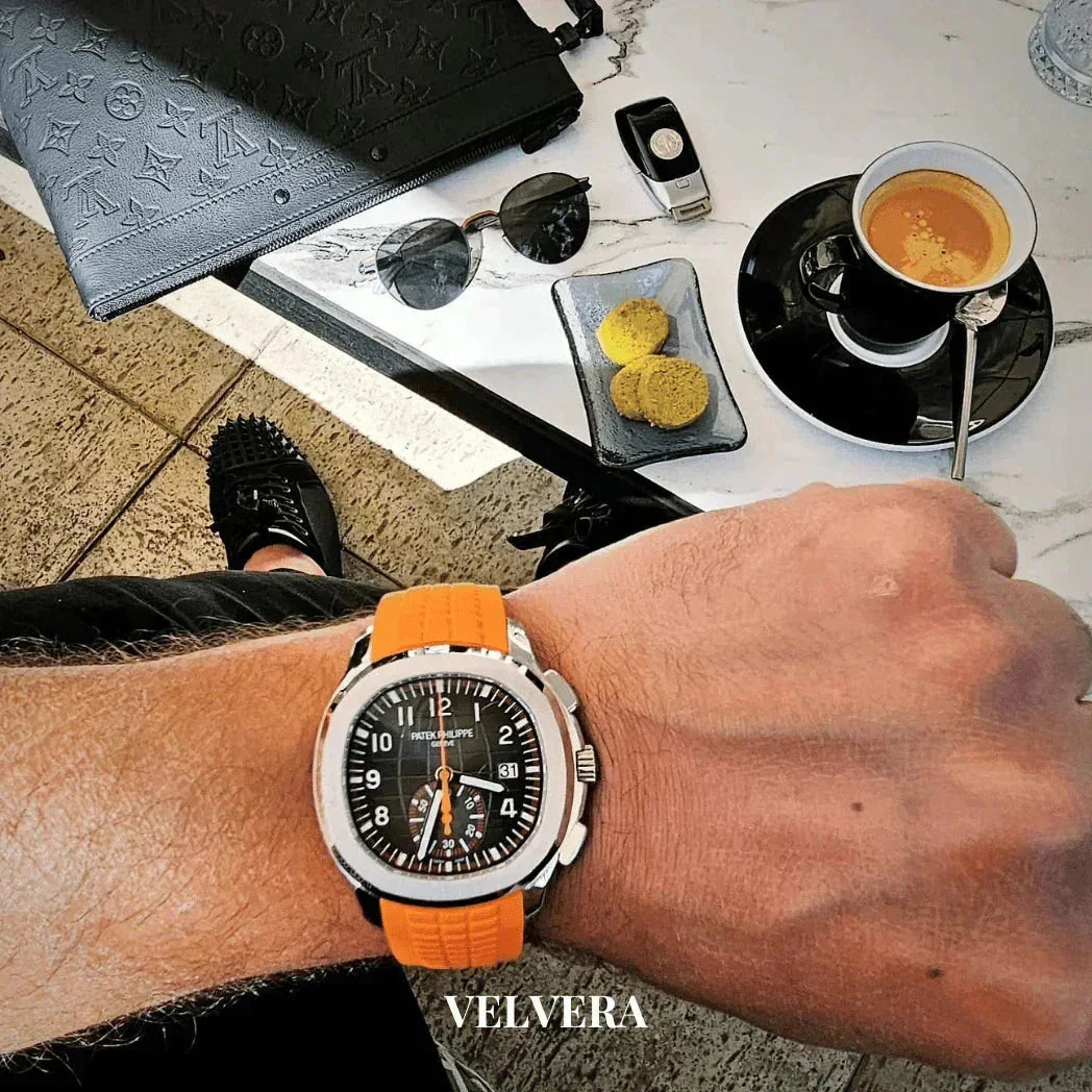 Luxury Patek Philippe watch with orange strap, coffee, cookies, sunglasses, and designer bag
