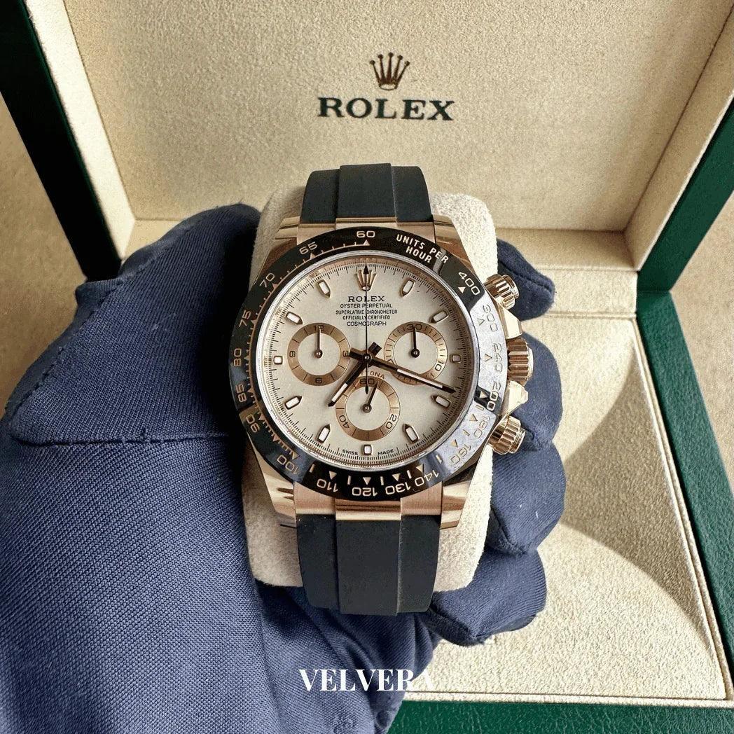 Rolex Daytona chronograph watch with black rubber strap in display box, closeup view