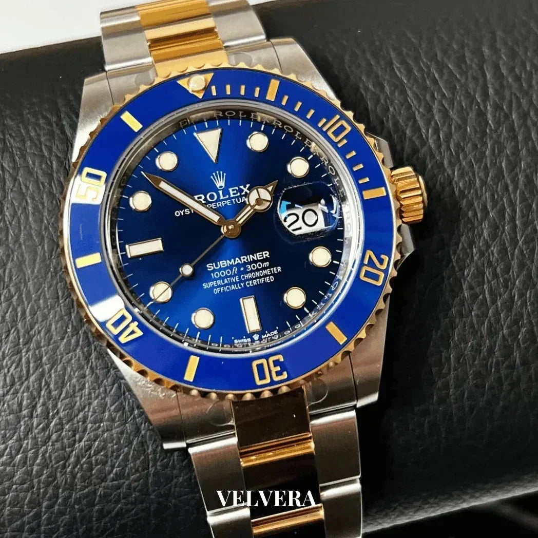 Rolex Submariner blue dial two-tone gold and steel watch on black leather background