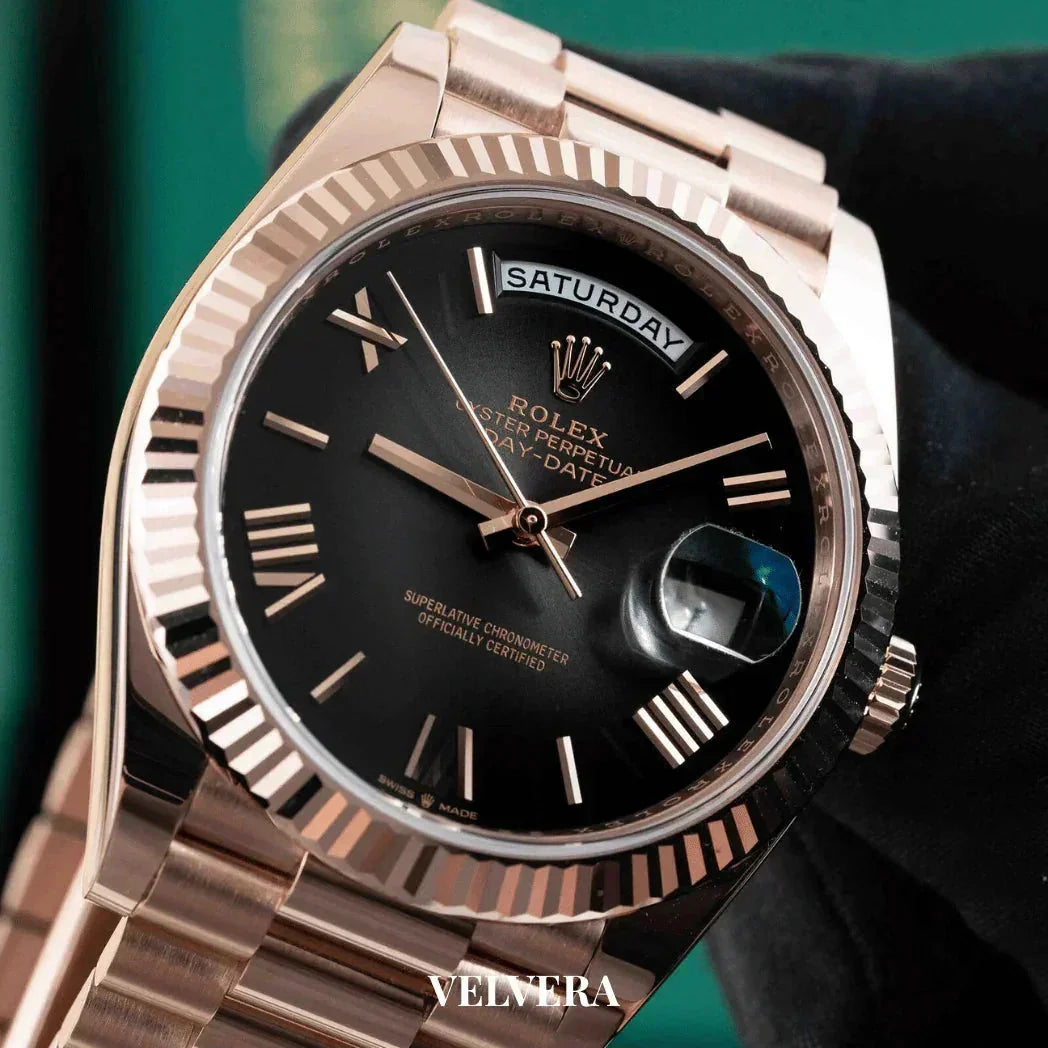 Rose gold Rolex Day-Date watch with black dial and Roman numerals, Velvera branding visible