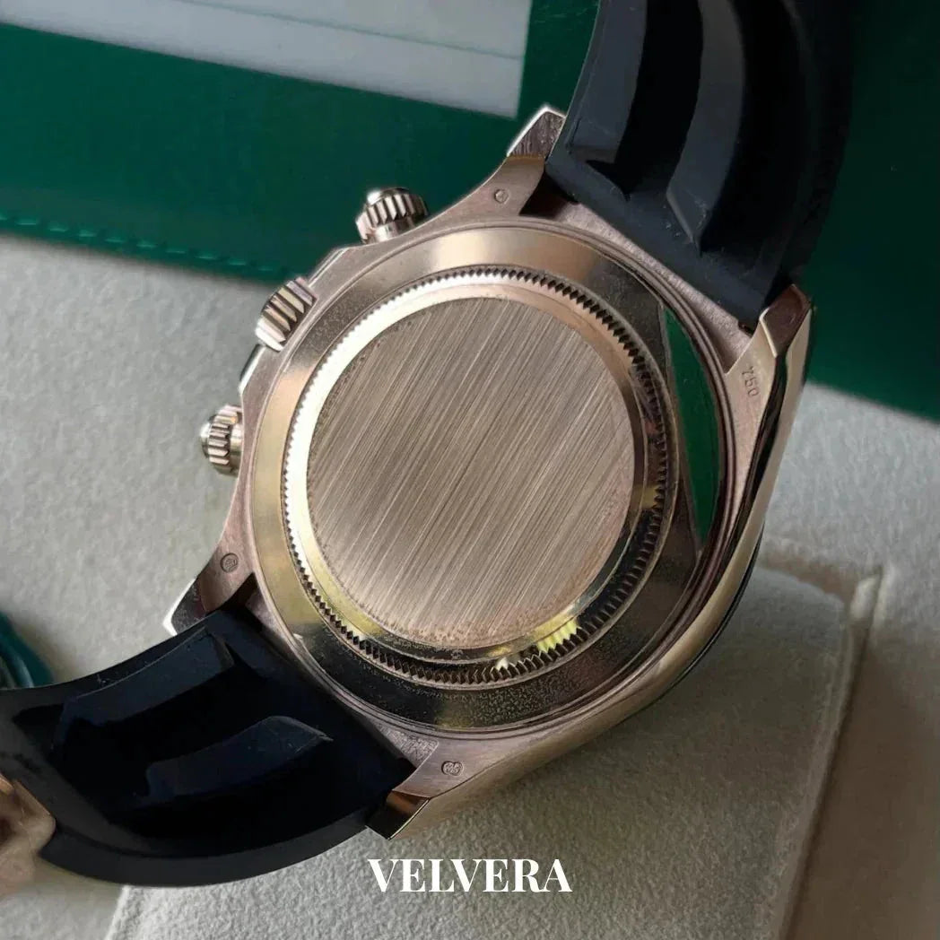 Close-up of luxury watch caseback with black strap and brushed metal finish, Velvera branding