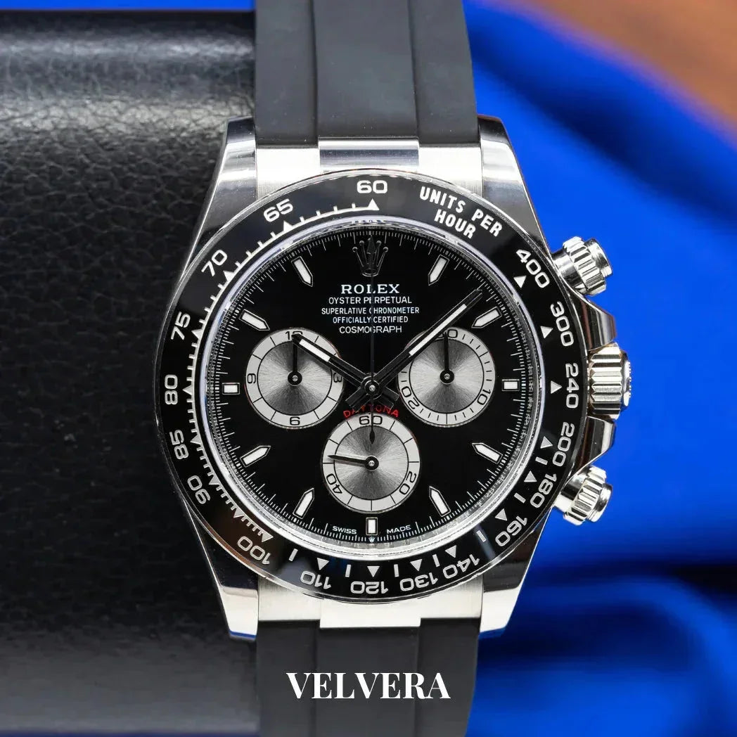 Rolex Daytona black chronograph watch with rubber strap on black leather, Velvera branding
