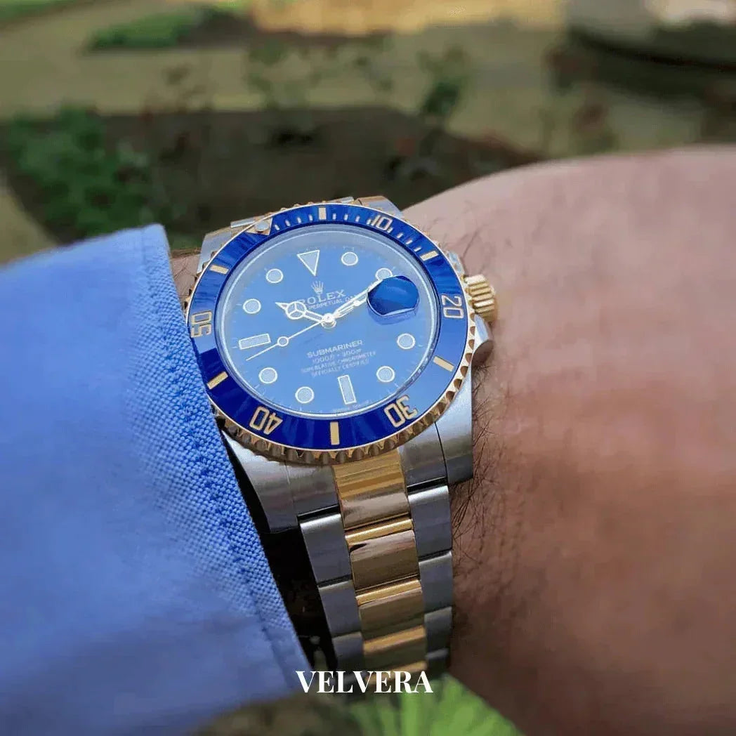 Blue dial Rolex Submariner two-tone gold and silver watch on wrist, VELVERA branding
