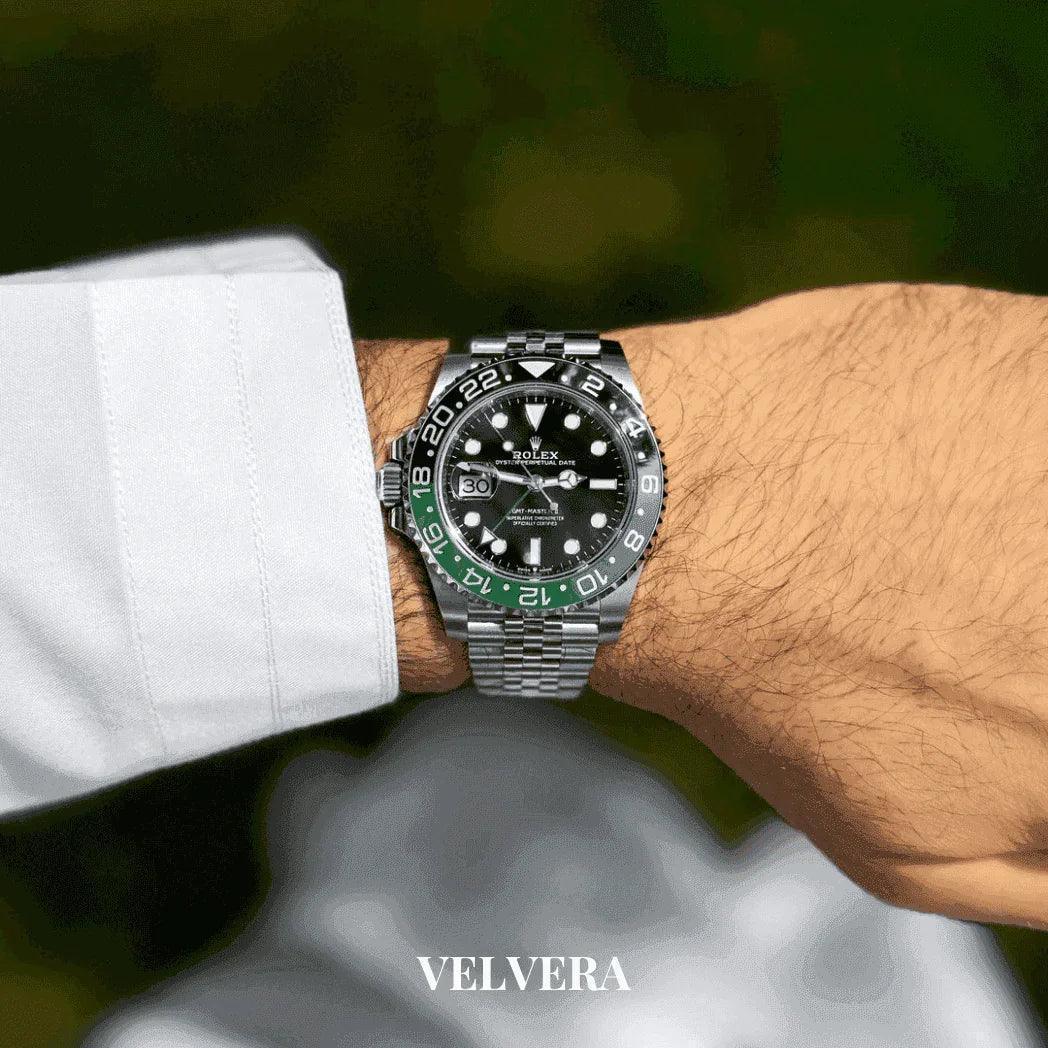 Luxury Rolex GMT-Master II watch with black and green bezel on man's wrist, VELVERA branding
