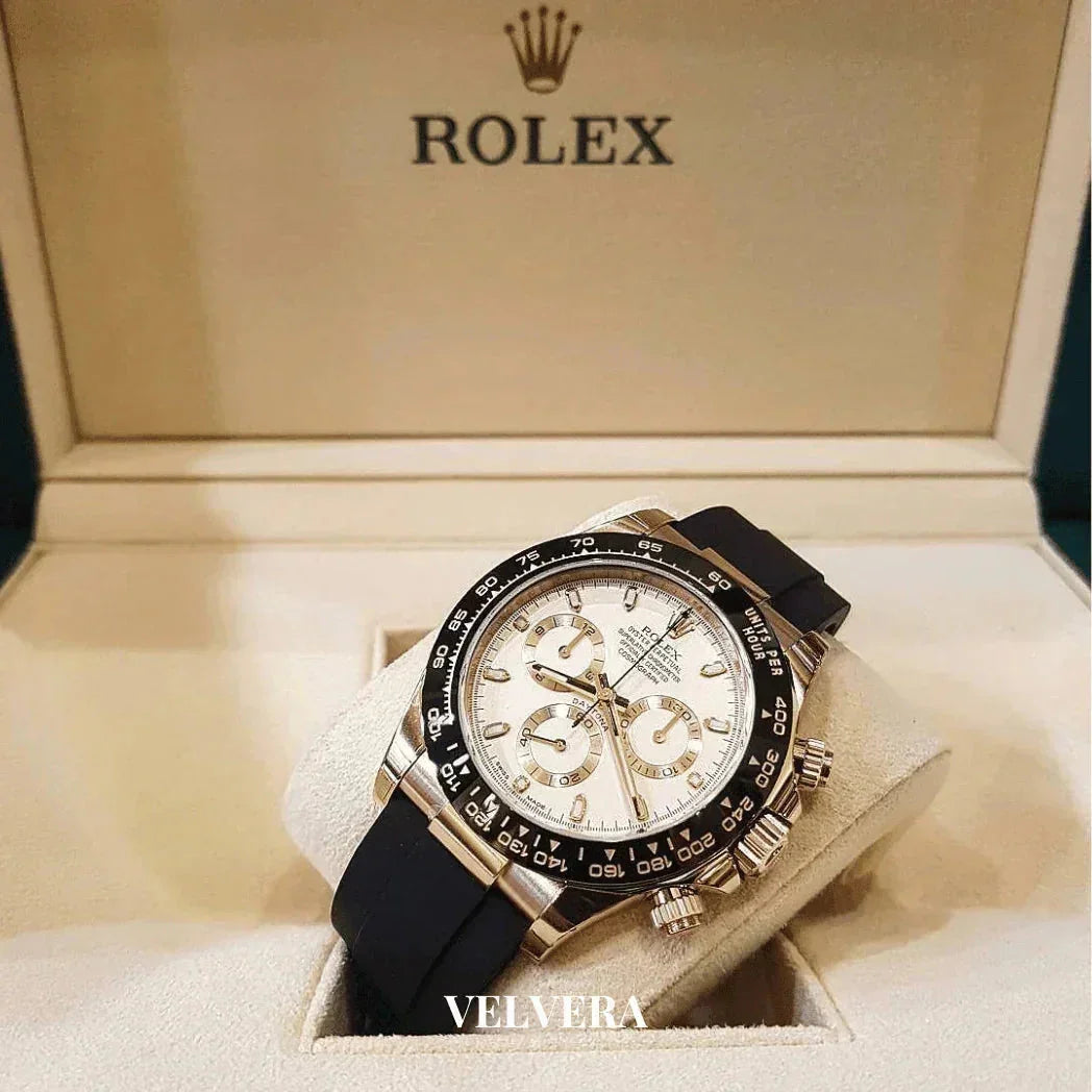 Rolex Daytona chronograph watch with black strap in branded display box, luxury timepiece
