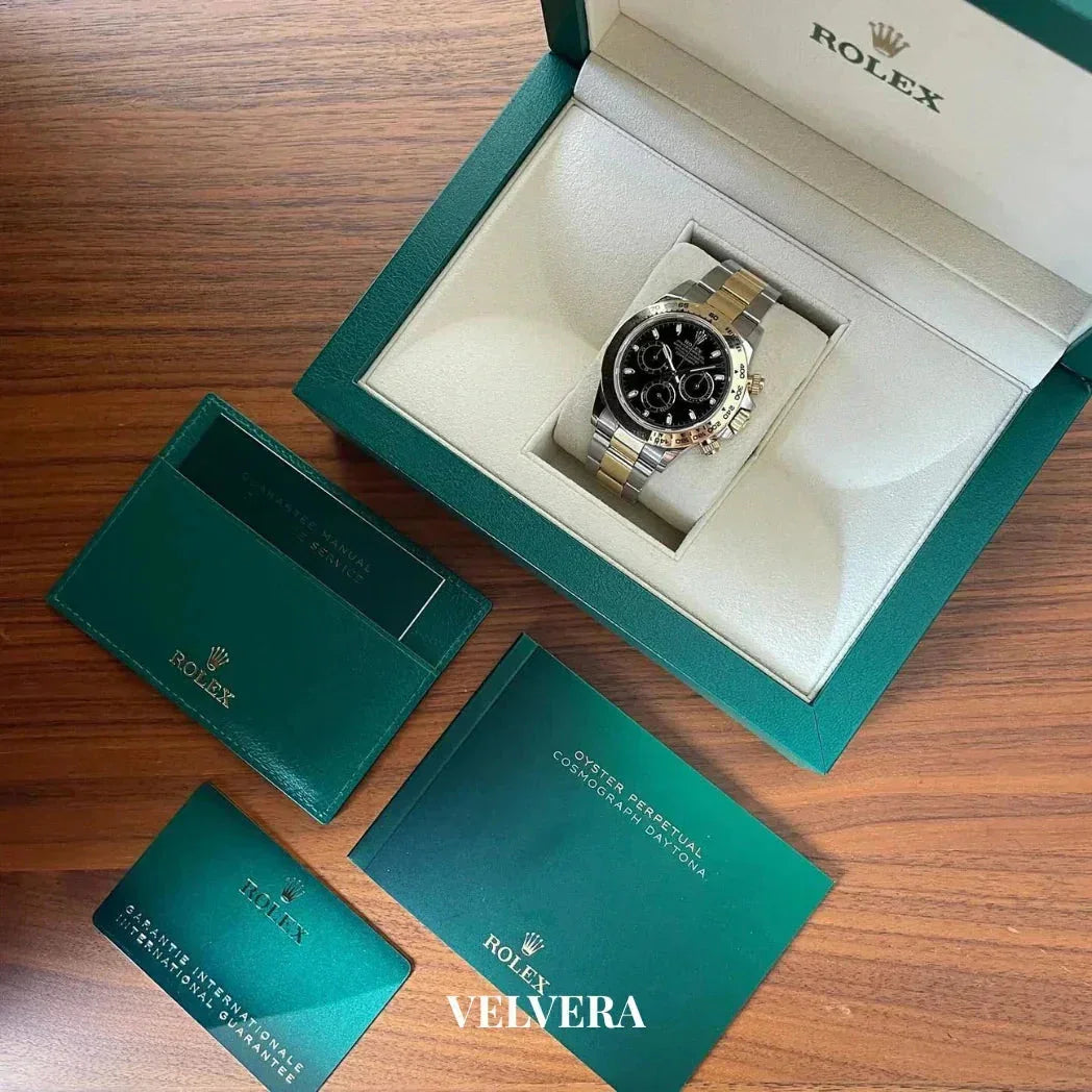 Rolex Cosmograph Daytona watch in green box with warranty card and manual on wooden table
