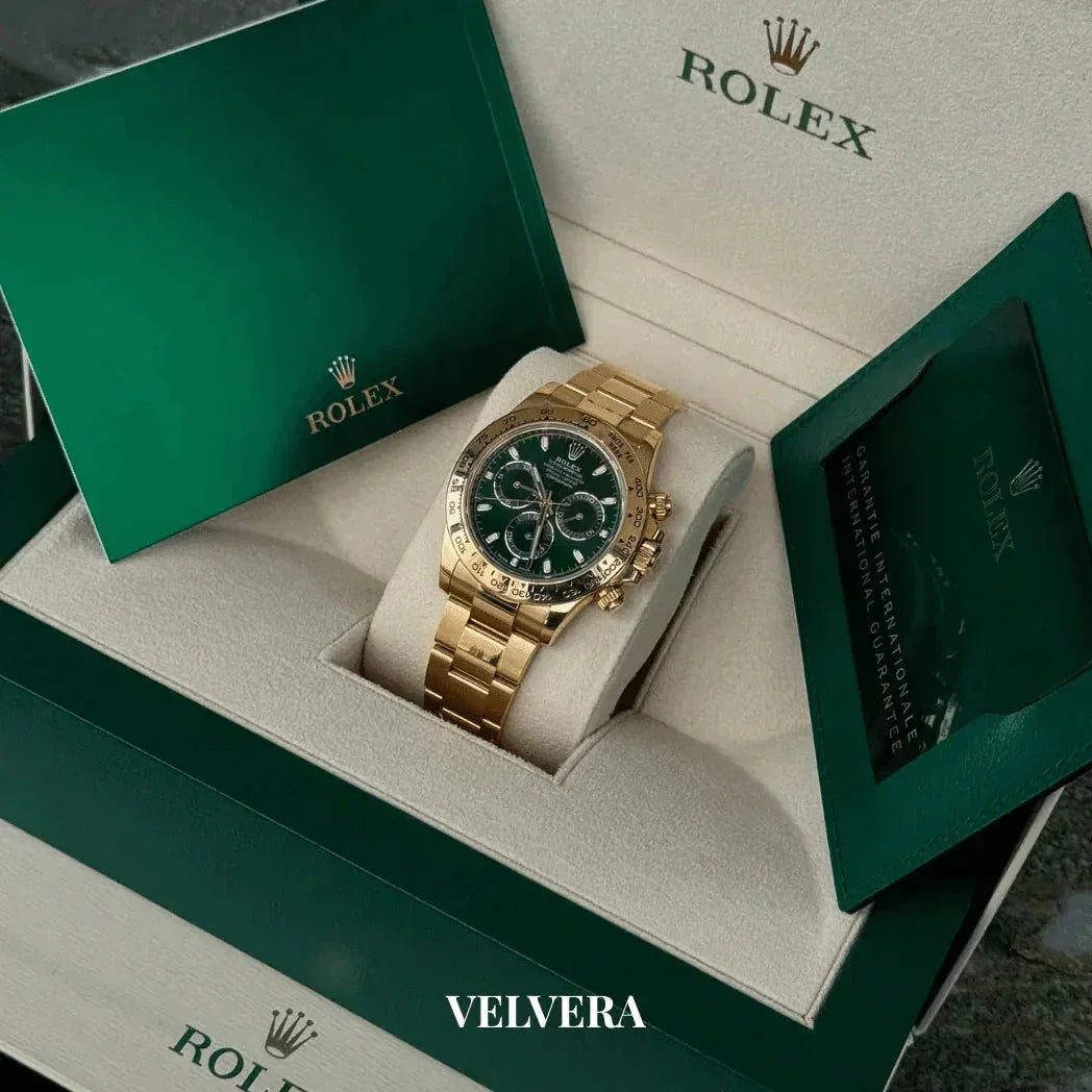 Gold Rolex Daytona watch with green dial in original box and packaging, luxury timepiece.