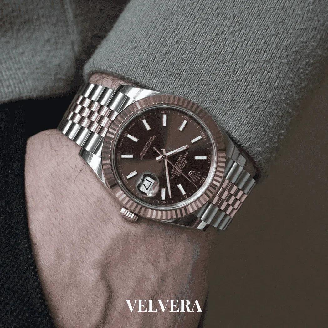 Luxury men's two-tone wristwatch with black dial on wrist, VELVERA branding visible.