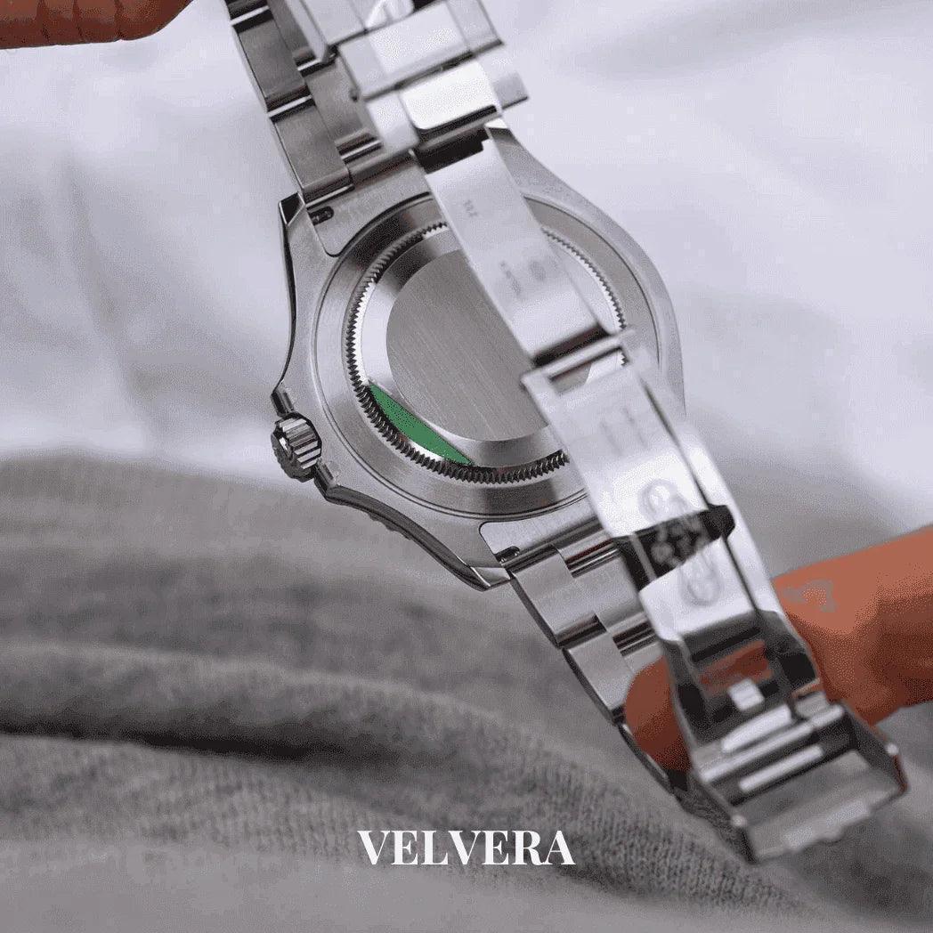 Velvera stainless steel watch back view with brushed metal bracelet on fabric background