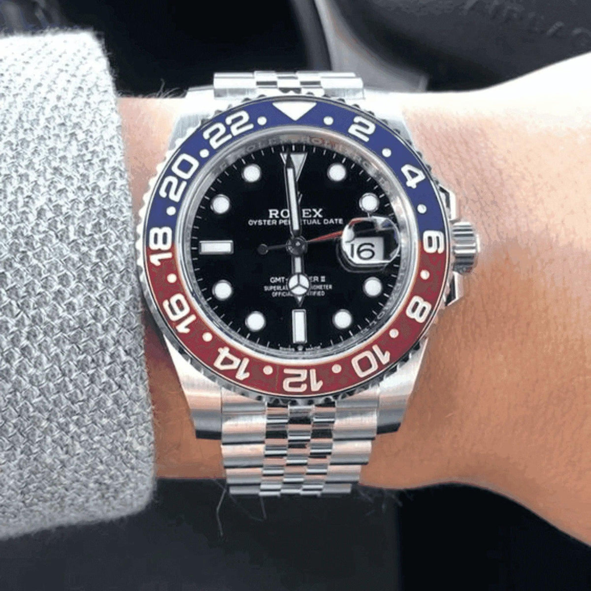 Rolex GMT-Master II Pepsi watch with blue and red bezel on wrist, silver jubilee bracelet