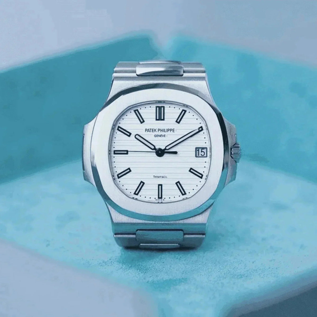 Patek Philippe Nautilus 5711/1A men’s stainless steel watch with white dial on blue background