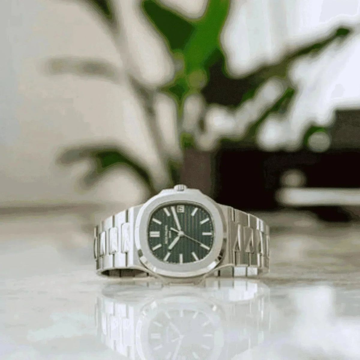 Patek Philippe Nautilus 5711A olive green dial men's watch on marble surface