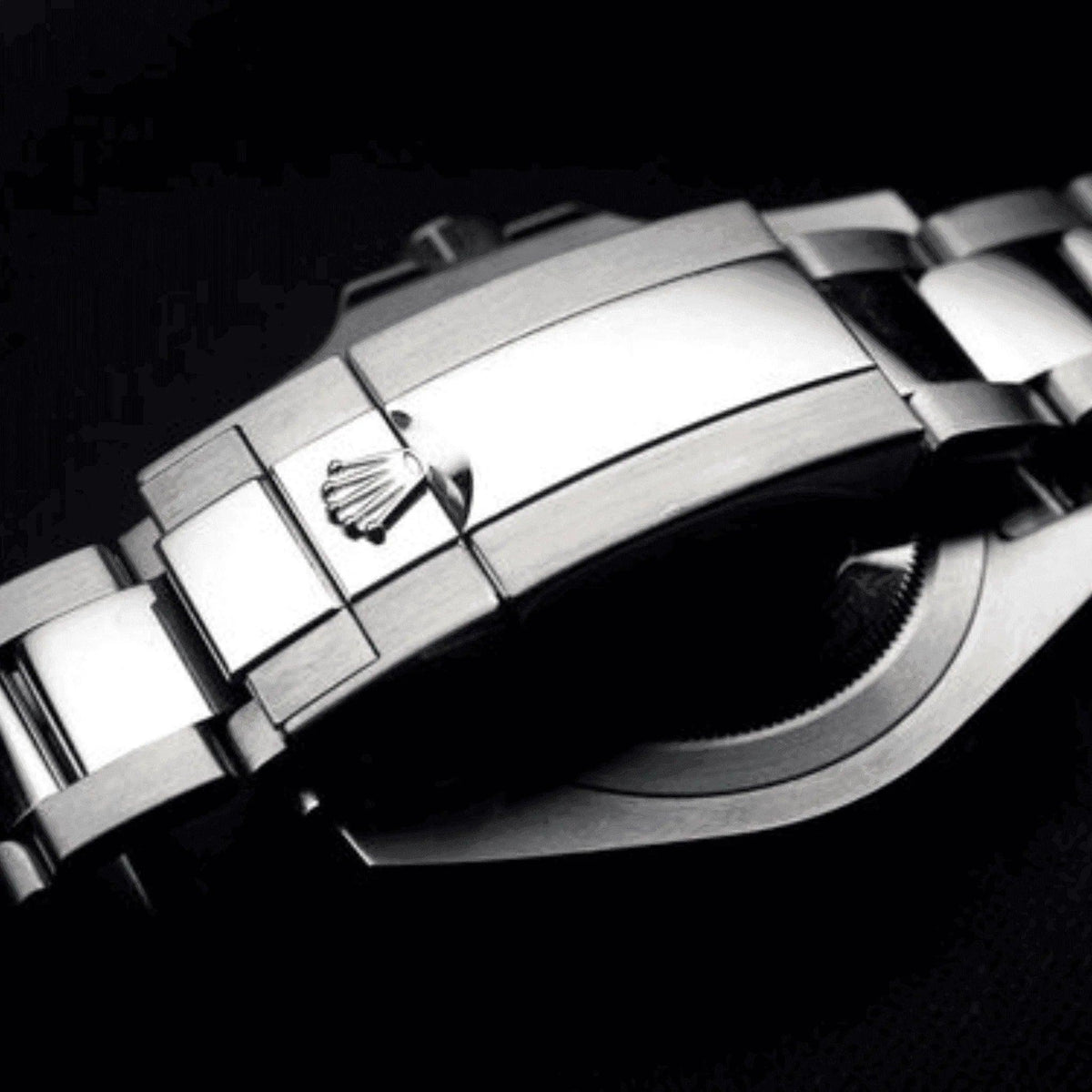 Stainless steel Rolex Submariner clasp with engraved crown logo on black background