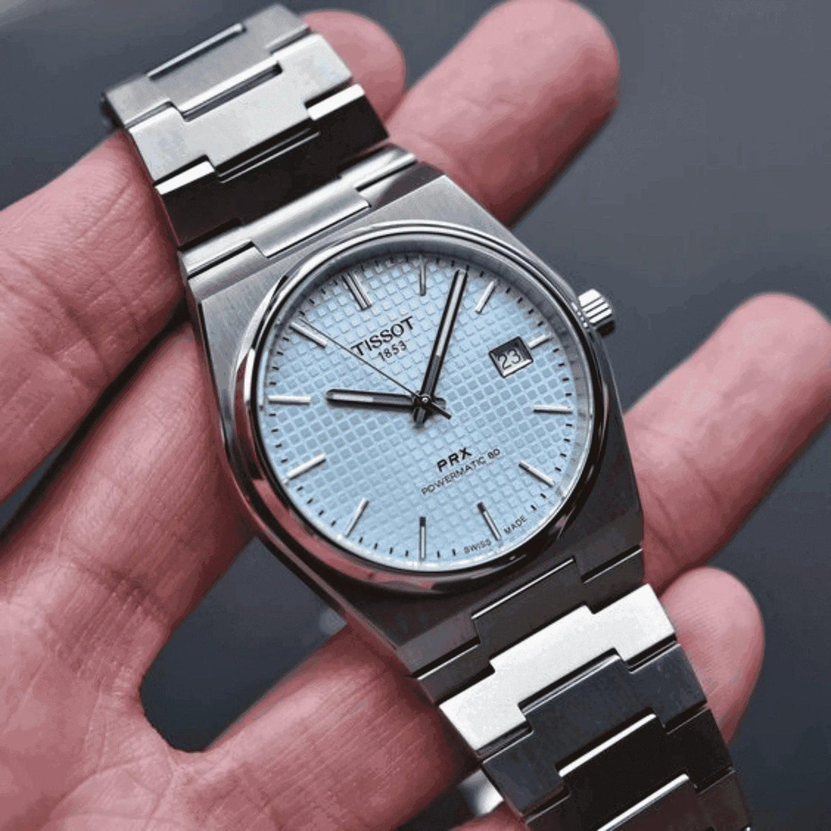 Tissot PRX Powermatic 80 men's stainless steel watch with ice blue dial on hand