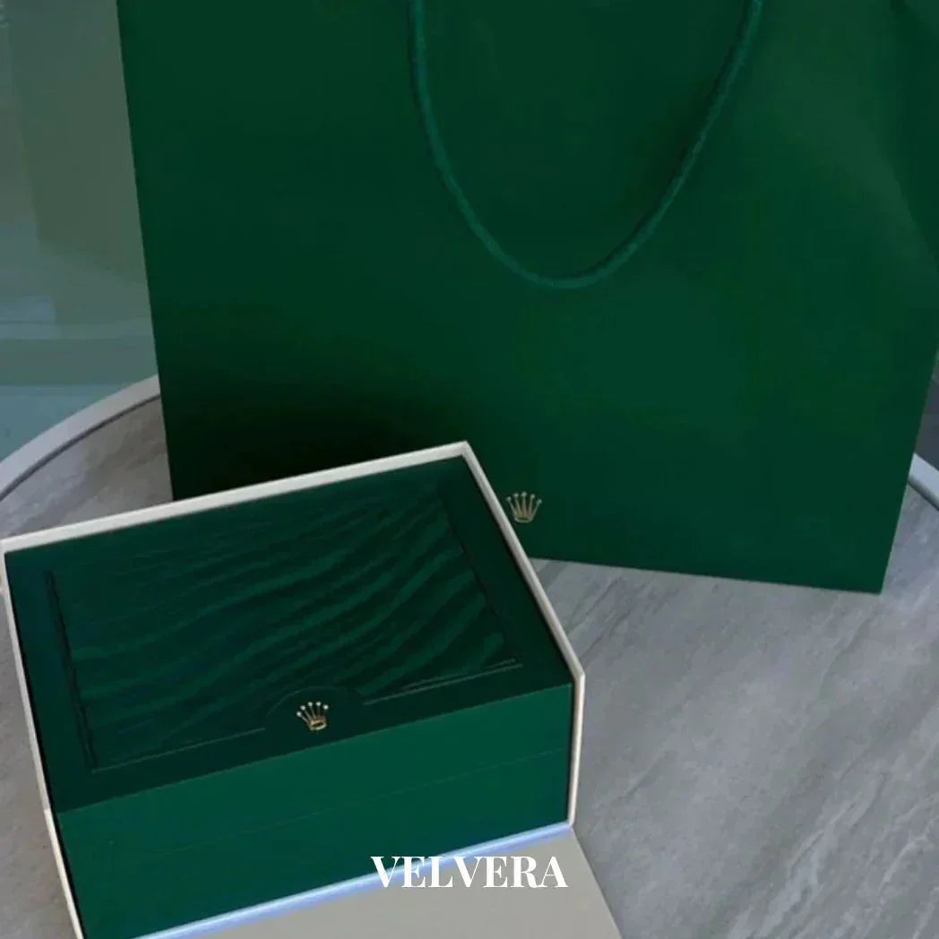 Luxury green Rolex watch box and shopping bag on table, VELVERA branding visible