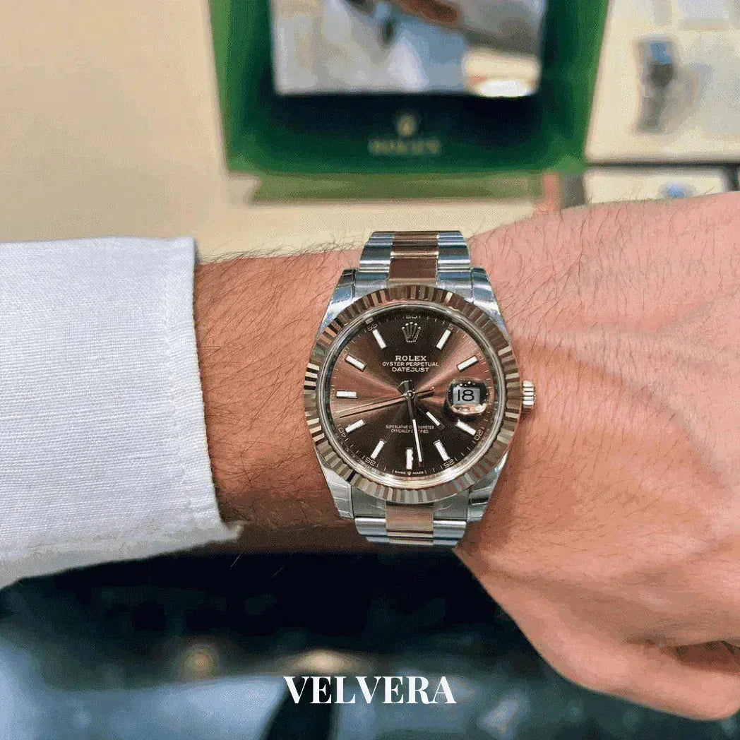 Two-tone Rolex Datejust watch with brown dial on wrist, white shirt, Velvera branding