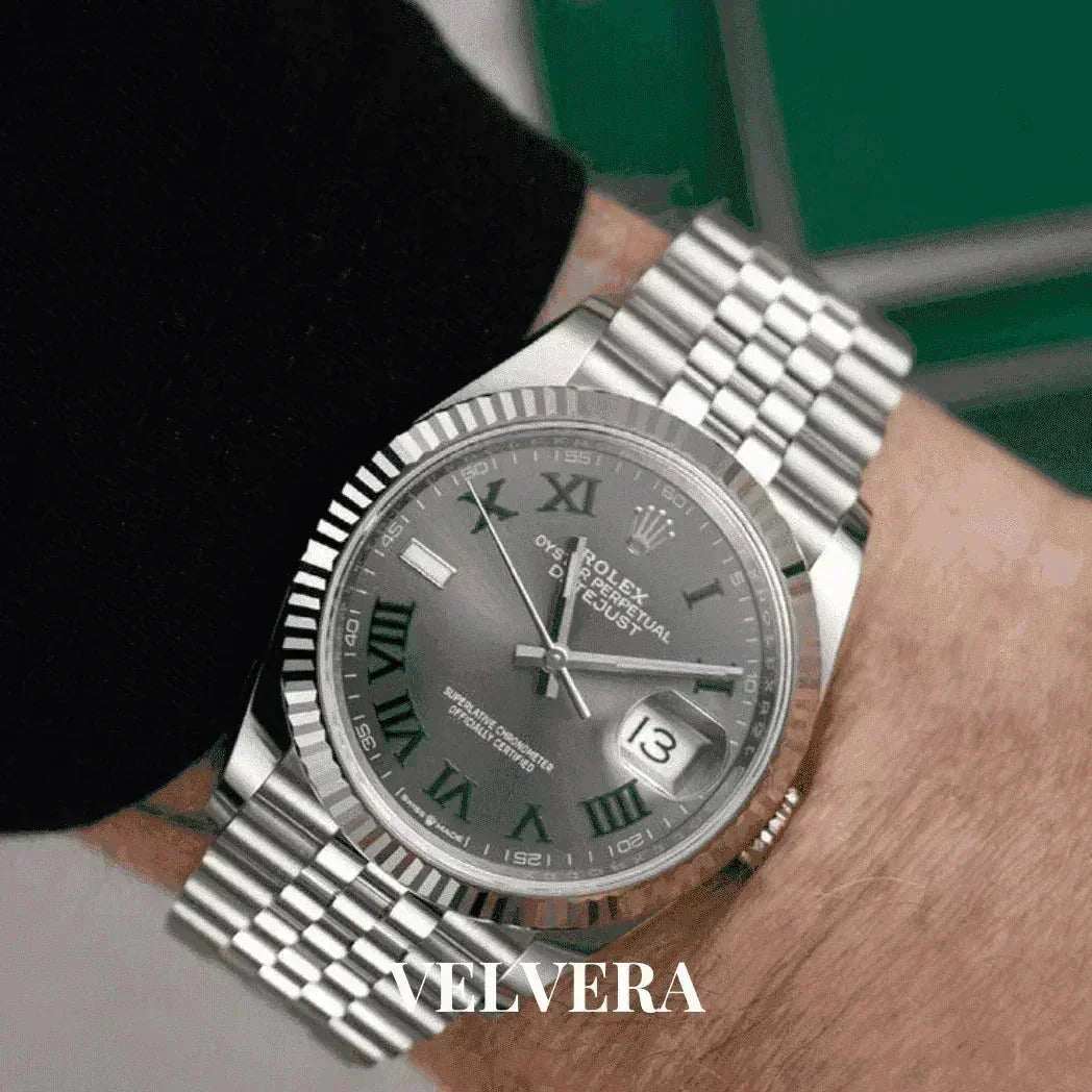 Silver Rolex Datejust watch with green roman numerals on wrist, Velvera branding visible
