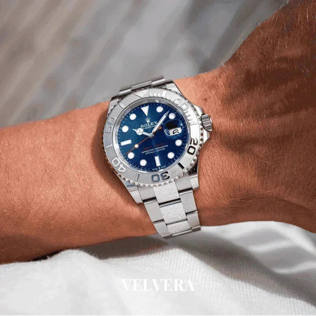 Luxury Rolex Yacht-Master silver watch with blue dial on wrist, VELVERA brand visible