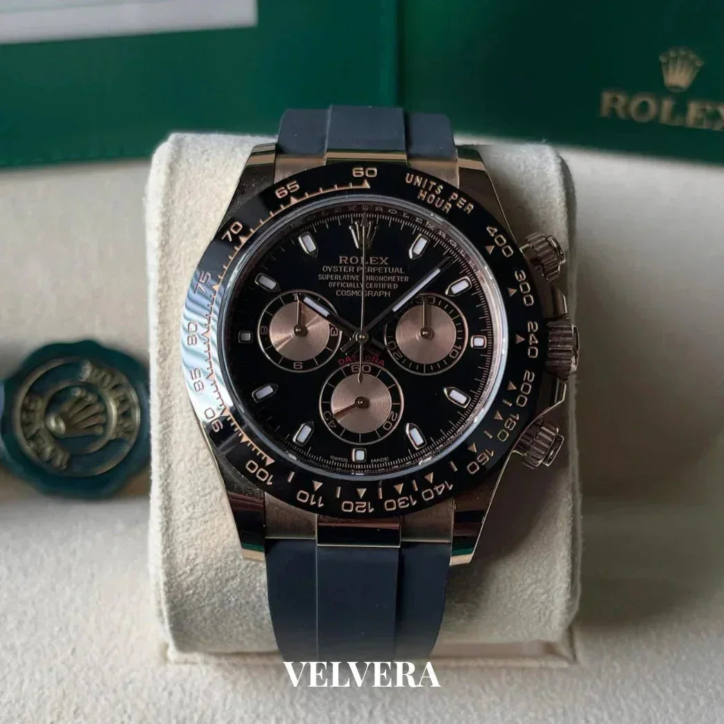 Rolex Oyster Perpetual black chronograph watch with rubber strap on display pillow, VELVERA branding