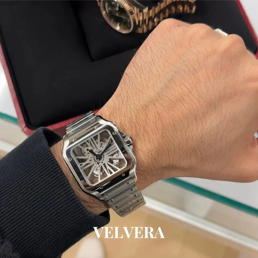 Luxury skeleton dial silver wristwatch on man's wrist, Velvera branding visible