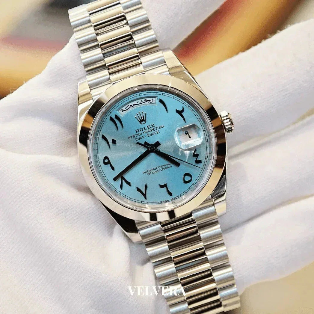 Rolex Oyster Perpetual Day-Date watch with Arabic numerals and ice blue dial on metal bracelet