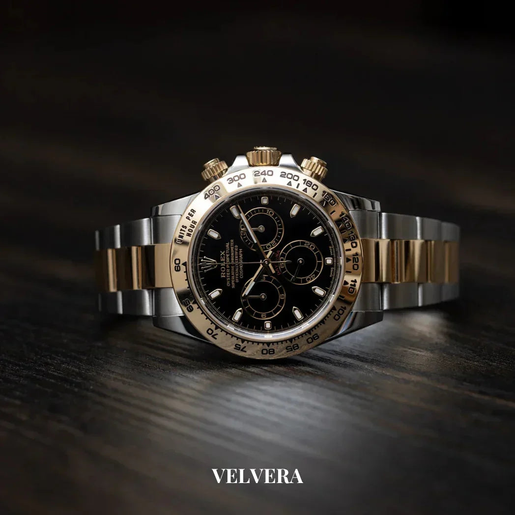 Luxury two-tone gold and stainless steel chronograph watch on dark wood, Velvera branding