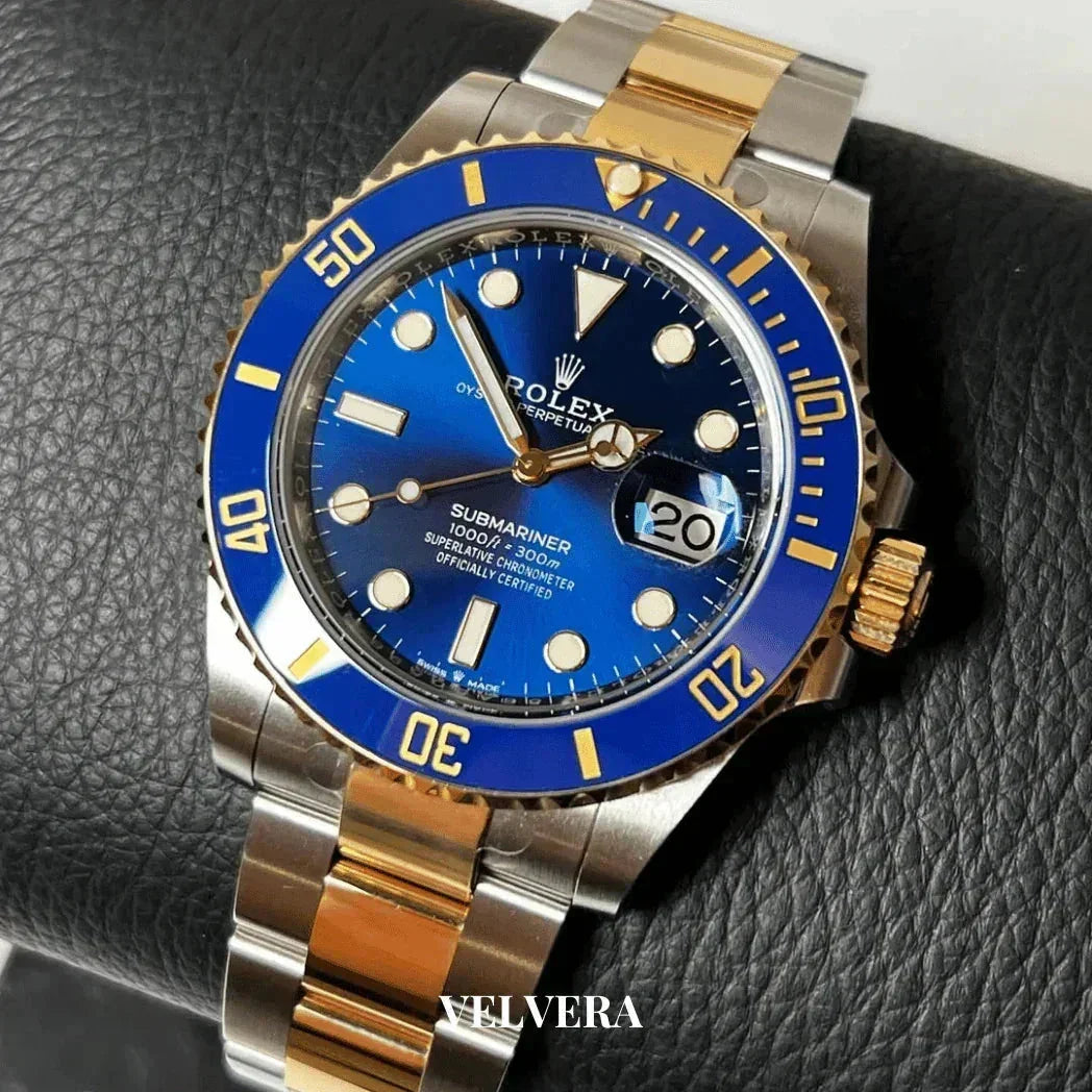 Rolex Submariner two-tone blue and gold luxury watch on black leather surface
