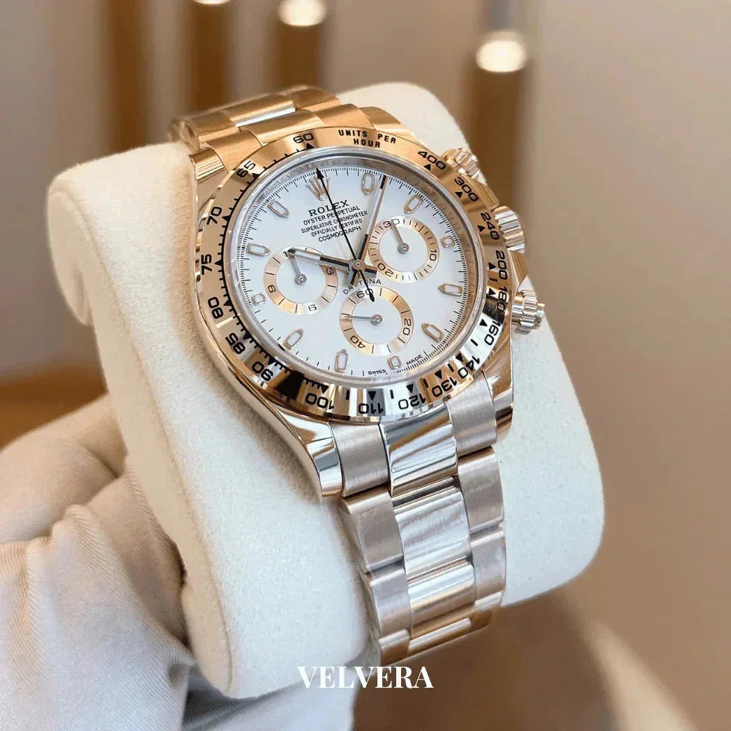 Luxury Rolex Daytona watch with white dial and gold stainless steel bracelet on display at Velvera