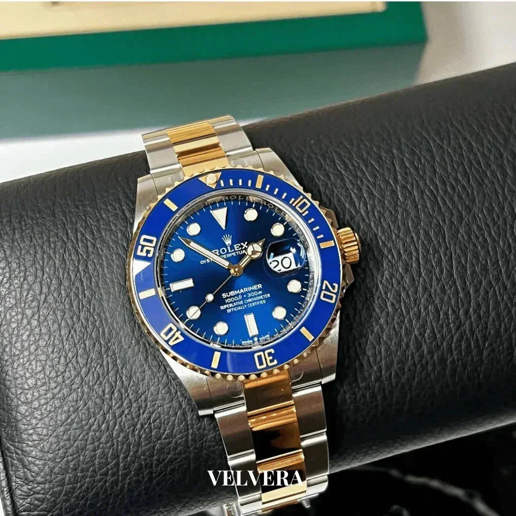 Rolex Submariner blue dial gold and silver two-tone watch on black leather display, Velvera