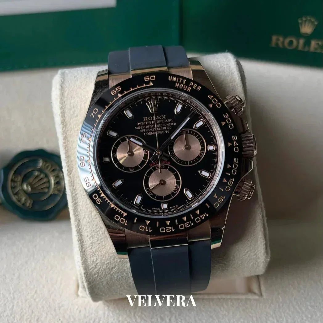 Rolex Daytona chronograph watch with black dial and rubber strap on display pillow