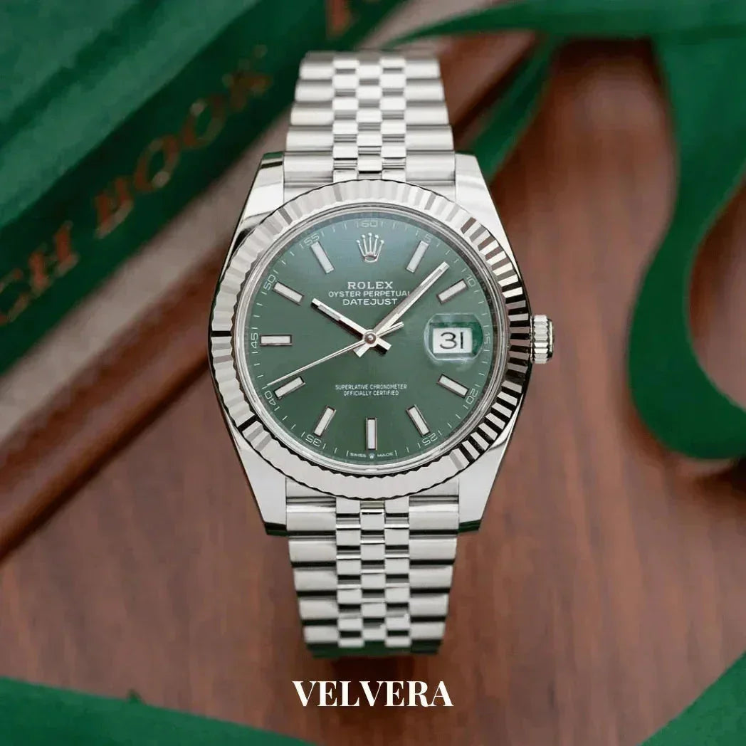Rolex Datejust green dial stainless steel watch on wooden surface with Velvera branding