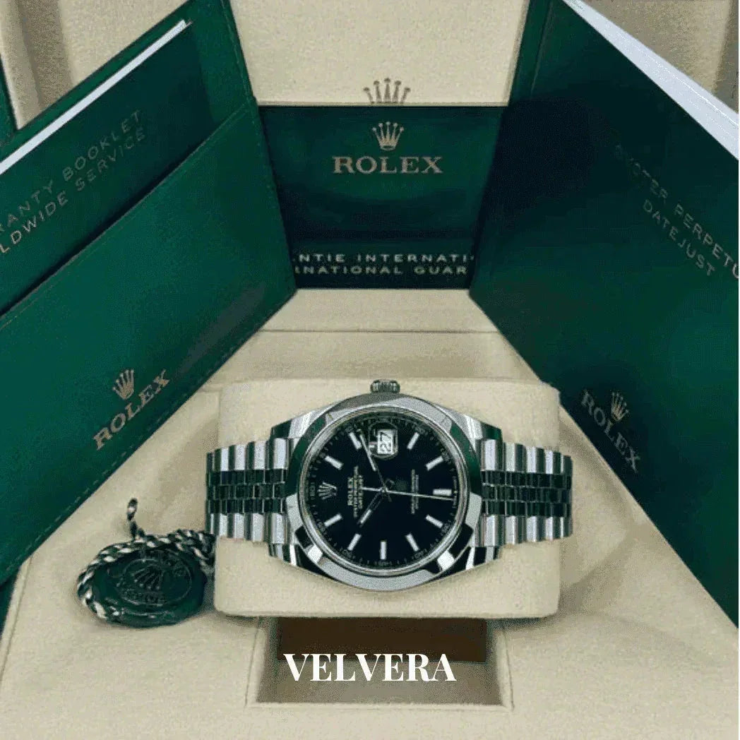Rolex Datejust watch with black dial, silver bracelet, and original green Rolex box set