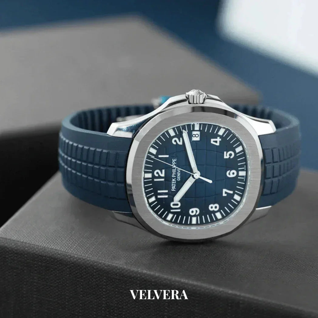 Blue rubber strap luxury watch with silver bezel on a dark box, Velvera branding visible
