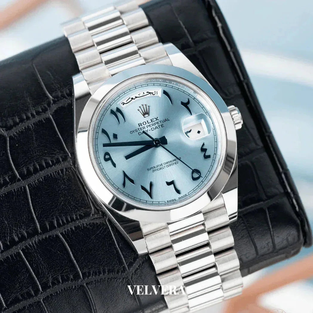 Rolex Oyster Perpetual Day-Date watch with ice blue Arabic dial on black leather wallet.