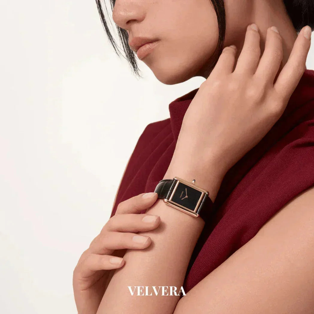 Woman wearing a Velvera rectangular black leather strap watch, burgundy outfit