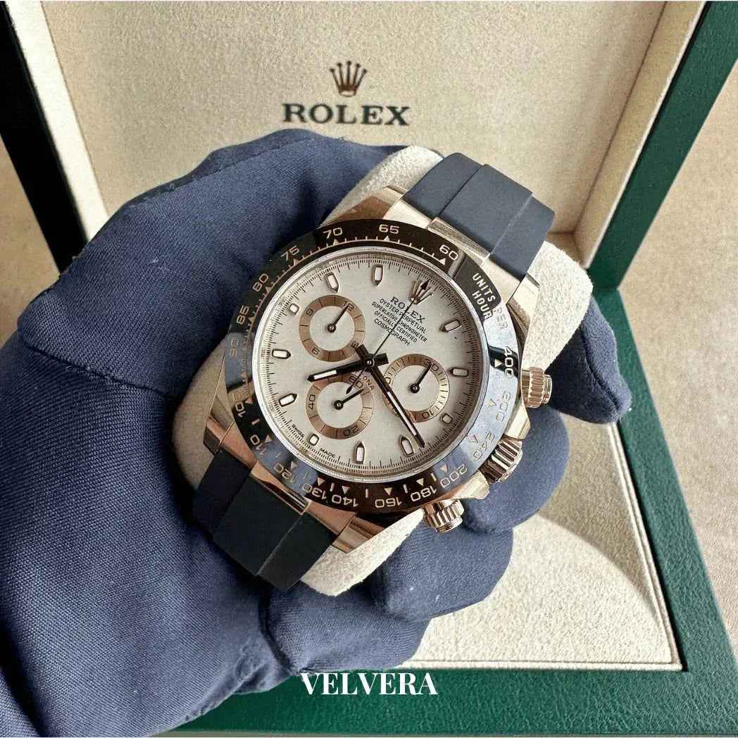 Rolex Daytona chronograph watch with black strap in luxury display box, gloved hand holding