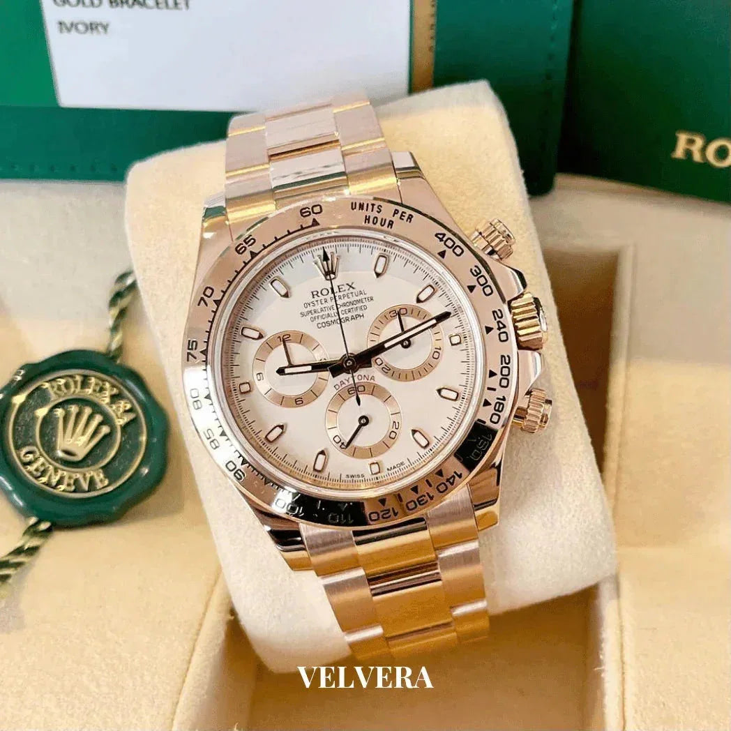 Rolex Daytona gold chronograph watch with ivory dial in box, green Rolex tag visible