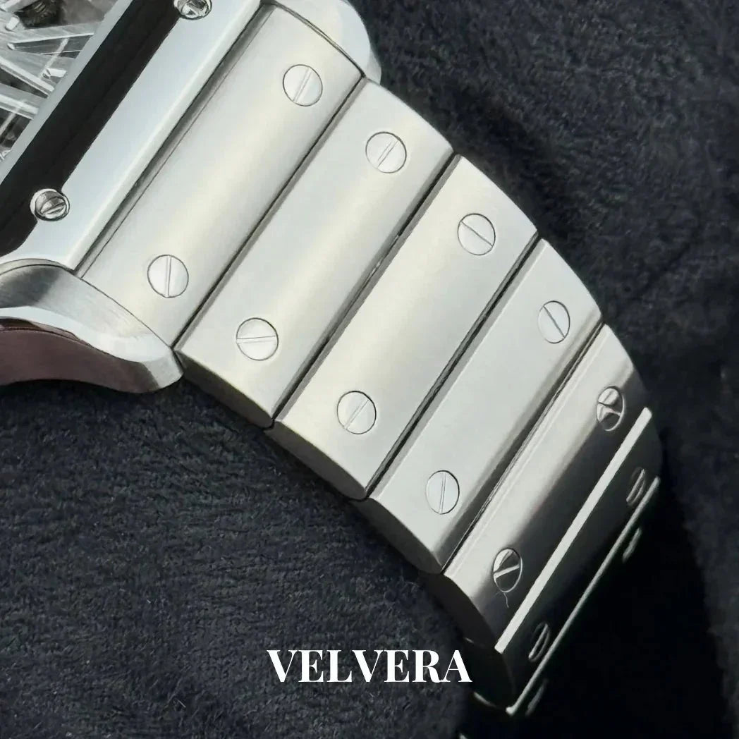 Close-up of Velvera stainless steel watch bracelet with screw details on black fabric.