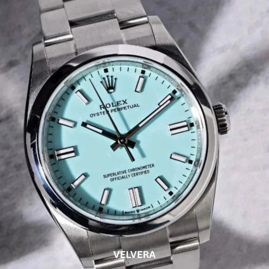 Rolex Oyster Perpetual watch with turquoise dial and stainless steel bracelet on gray background