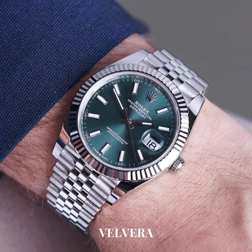Rolex Datejust silver watch with green dial on wrist, silver jubilee bracelet, Velvera logo