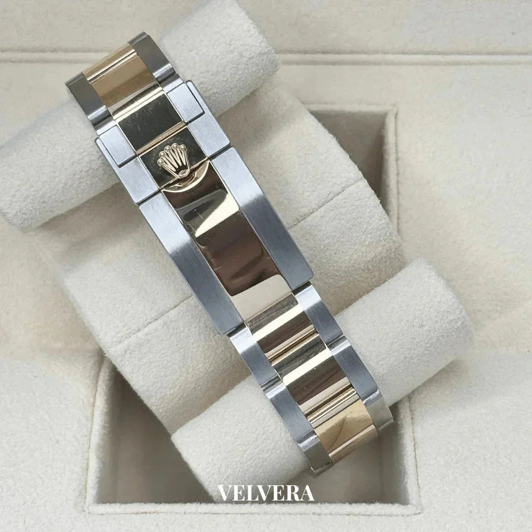 Two-tone Rolex watch bracelet with gold and stainless steel links in a beige display box