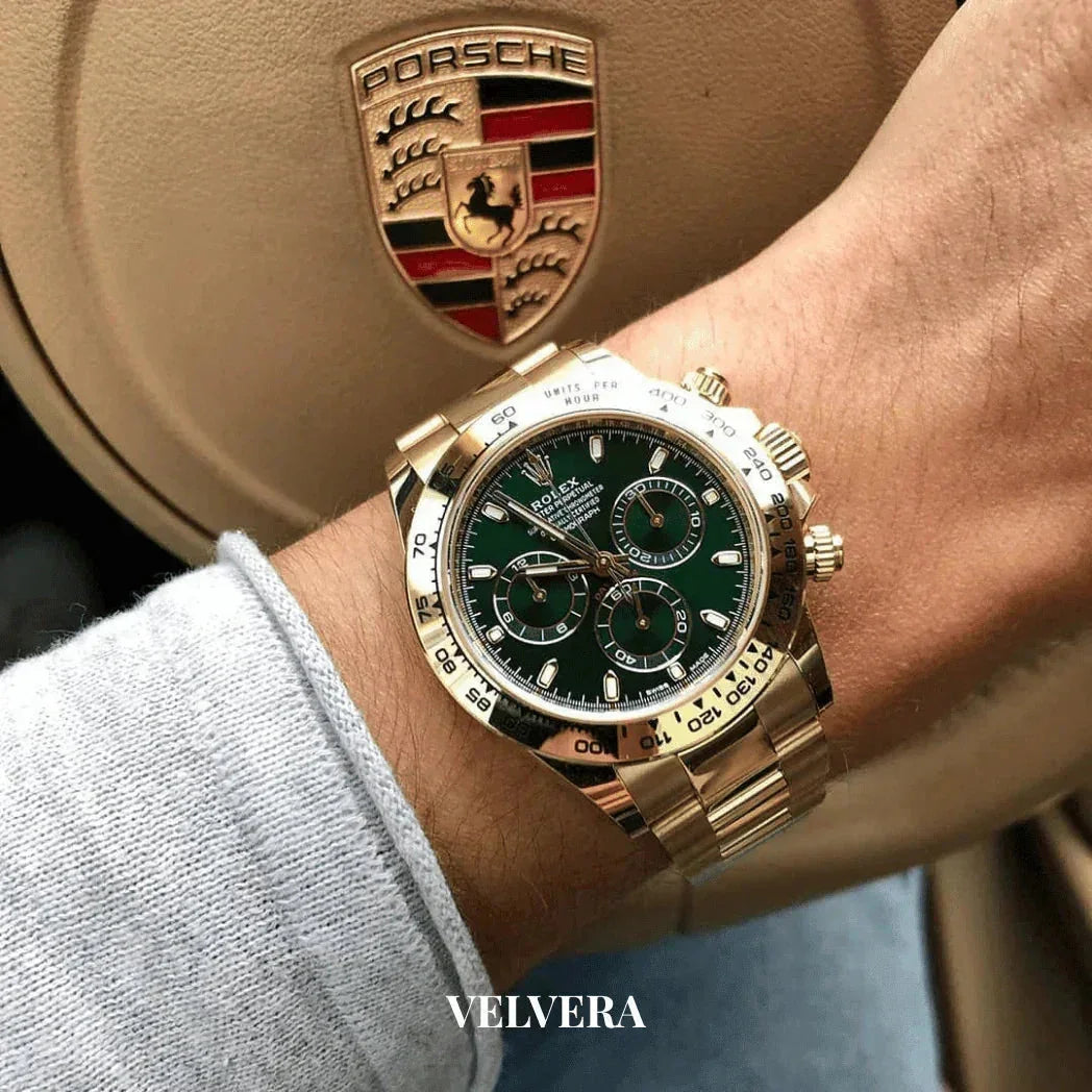 Gold Rolex Daytona green dial on wrist, Porsche steering wheel, luxury watch style