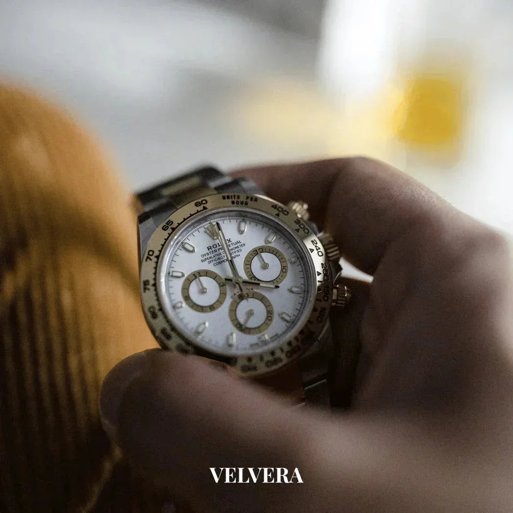 Luxury Rolex Daytona gold and silver watch on wrist, Velvera branding visible